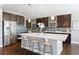 Bright kitchen features dark wood cabinets, stainless appliances, light countertops, and pendant lighting at 16069 Pikes Peak Dr, Broomfield, CO 80023