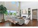Elegant living room with a cozy fireplace and large windows offering beautiful natural light at 16069 Pikes Peak Dr, Broomfield, CO 80023