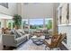 Bright and open living room with tall ceilings, fireplace, and large windows with mountain views at 16069 Pikes Peak Dr, Broomfield, CO 80023