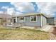 Well-maintained backyard with a wooden deck, patio furniture, and a lush lawn, perfect for outdoor activities at 9139 Flora St, Arvada, CO 80005