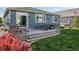 Cozy backyard featuring a wood deck with a dining set and a grill, perfect for outdoor entertaining at 9139 Flora St, Arvada, CO 80005