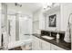 Modern bathroom features a stylish vanity with a granite countertop and a sleek, glass-enclosed shower at 9139 Flora St, Arvada, CO 80005