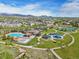 Beautiful aerial view of a community with a pool, playground, and mountain backdrop on a sunny day at 9139 Flora St, Arvada, CO 80005