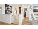 Bright entryway featuring unique artwork, wood floors, and access to living spaces, creating an inviting atmosphere at 9139 Flora St, Arvada, CO 80005