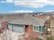 Charming home with a three car garage boasts stone accents, a stylish entry, and great curb appeal at 9139 Flora St, Arvada, CO 80005