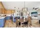 Lovely kitchen and dining area with ample cabinets, stainless appliances, a large island and wood floors at 9139 Flora St, Arvada, CO 80005