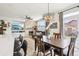 Open living room and dining area with fireplace, hardwood floors and lots of natural light at 9139 Flora St, Arvada, CO 80005