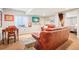 Comfortable living room with plush seating, a media center, and a walkout to the basement bedroom at 9139 Flora St, Arvada, CO 80005
