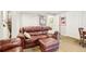 Basement living room with comfortable leather sofas, decorative pillows, and a side table with wood accents at 9139 Flora St, Arvada, CO 80005