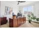 Bright office with a large window, wooden desk, filing cabinet, and a potted plant for a touch of nature at 9139 Flora St, Arvada, CO 80005
