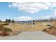 Community playground in neighborhood with swings, slides, and a wood chip groundcover at 9139 Flora St, Arvada, CO 80005