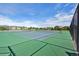 Close-up of well-maintained community tennis courts on a sunny day with clear blue skies at 9139 Flora St, Arvada, CO 80005