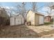 A backyard featuring two sheds and overgrown greenery at 1540 E 95Th Ave, Thornton, CO 80229