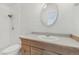 Traditional bathroom featuring a wood vanity, white fixtures, and a shower-tub combination at 1540 E 95Th Ave, Thornton, CO 80229