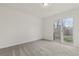 Bright bedroom with neutral carpet and a sliding glass door leading to the backyard at 1540 E 95Th Ave, Thornton, CO 80229