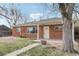 Lovely red brick home with a tidy lawn and a covered front porch, complemented by mature trees at 1540 E 95Th Ave, Thornton, CO 80229