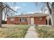 Charming red brick home with a well-manicured lawn and inviting walkway to the front door at 1540 E 95Th Ave, Thornton, CO 80229