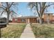 Inviting brick home with a well-maintained lawn and a pathway leading to the front entrance at 1540 E 95Th Ave, Thornton, CO 80229