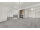 Open living room featuring a brick fireplace and neutral carpeting for a warm, inviting space at 1540 E 95Th Ave, Thornton, CO 80229