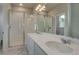 Bright bathroom with double sinks, ample counter space, and a walk-in shower with glass doors at 1310 Hoyt St # 6, Lakewood, CO 80215