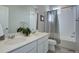 Bright bathroom featuring double sinks, tile flooring, a shower with tub, and decor at 1310 Hoyt St # 6, Lakewood, CO 80215