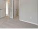 This carpeted bedroom features neutral walls, white trim and baseboards, and a view into the hallway at 1310 Hoyt St # 6, Lakewood, CO 80215