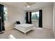 Bright bedroom with a ceiling fan, two windows offering ample natural light, and modern decor at 1310 Hoyt St # 6, Lakewood, CO 80215