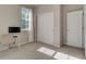 Bright bedroom featuring neutral walls, carpet, closet, a large window, and space for a desk at 1310 Hoyt St # 6, Lakewood, CO 80215
