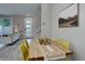 Inviting dining area showcasing a wooden table, yellow chairs, and an open-concept layout to the living area at 1310 Hoyt St # 6, Lakewood, CO 80215