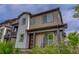 Modern two-story home boasts a red door and landscaped front yard with pink flowers at 1310 Hoyt St # 6, Lakewood, CO 80215