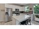Beautiful kitchen featuring stainless steel appliances, a center island with seating, and sleek finishes at 1310 Hoyt St # 6, Lakewood, CO 80215
