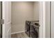 This laundry room features a modern washer and dryer, neutral walls, and tile flooring at 1310 Hoyt St # 6, Lakewood, CO 80215