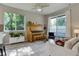 Cozy living room with natural light, neutral colors, a piano, and access to the outdoor patio at 1310 Hoyt St # 6, Lakewood, CO 80215