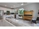 Bright, open living room featuring a piano, stainless steel appliances, and neutral color palette at 1310 Hoyt St # 6, Lakewood, CO 80215
