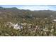 Scenic aerial view of a home surrounded by lush forest and distant mountains at 28539 Douglas Park Rd, Evergreen, CO 80439