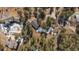 Aerial view of a house nestled among trees, featuring a long driveway at 28539 Douglas Park Rd, Evergreen, CO 80439