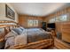 Bedroom with hardwood floors, and a wooden frame bed at 28539 Douglas Park Rd, Evergreen, CO 80439