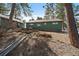 Exterior of the house with stone accents and a well-maintained backyard at 28539 Douglas Park Rd, Evergreen, CO 80439