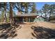 Charming single-story home with a stone chimney and a detached two-car garage nestled among mature trees at 28539 Douglas Park Rd, Evergreen, CO 80439