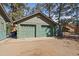 Two-car garage with charming green doors at 28539 Douglas Park Rd, Evergreen, CO 80439