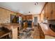 Well-lit kitchen featuring stainless steel appliances and a rustic breakfast bar at 28539 Douglas Park Rd, Evergreen, CO 80439