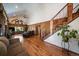 Spacious living room boasting wood-paneled walls, hardwood floors, and a vaulted ceiling at 28539 Douglas Park Rd, Evergreen, CO 80439