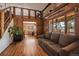 Spacious living room features hardwood floors, exposed beams, and access to the outside at 28539 Douglas Park Rd, Evergreen, CO 80439
