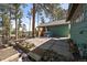 Relaxing outdoor patio with mature trees and sunny skies at 28539 Douglas Park Rd, Evergreen, CO 80439
