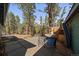 Outdoor patio surrounded by lush trees offering a serene escape at 28539 Douglas Park Rd, Evergreen, CO 80439