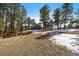 Spacious yard and mature trees in the background at 28539 Douglas Park Rd, Evergreen, CO 80439