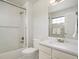 A well-lit bathroom with tiled shower and tub combo, granite counters, and vanity at 9467 W Plymouth Ave, Littleton, CO 80128