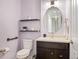 Half bathroom featuring a vanity with a dark cabinet, soft lavender walls, and modern fixtures at 9467 W Plymouth Ave, Littleton, CO 80128