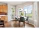 Cozy dining area with large windows, backyard views, and a door to outdoor area at 9467 W Plymouth Ave, Littleton, CO 80128