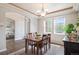 Dining room with hardwood floors, a wooden table set for four, and lots of natural light at 9467 W Plymouth Ave, Littleton, CO 80128